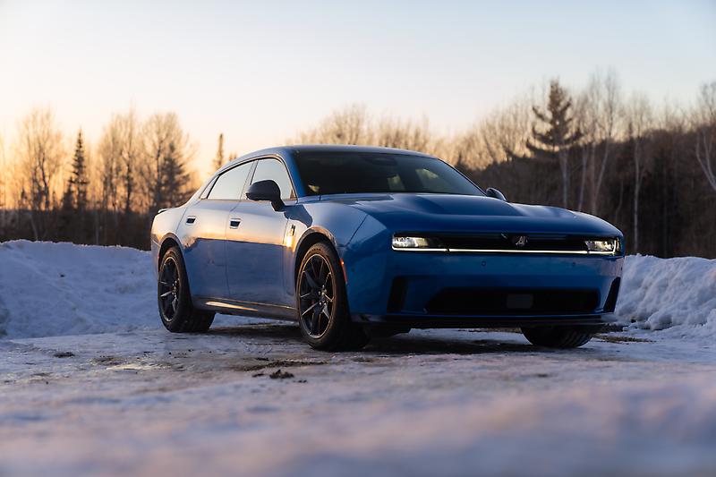 Koyu mavi gövdeli Dodge Charger'ın karlı zeminde önden üç çeyrek görünümü